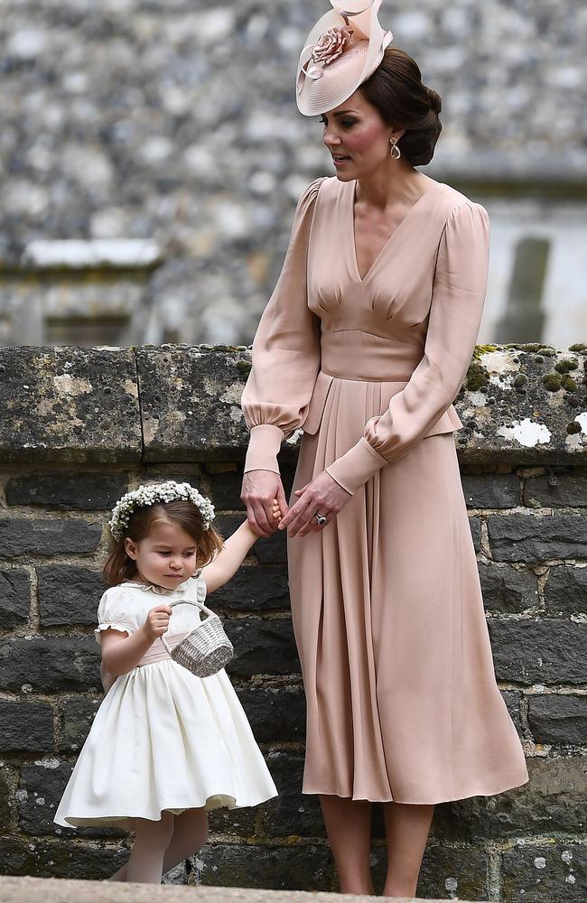 The Duchess stands quietly with daughter Charlotte after the ceremony.