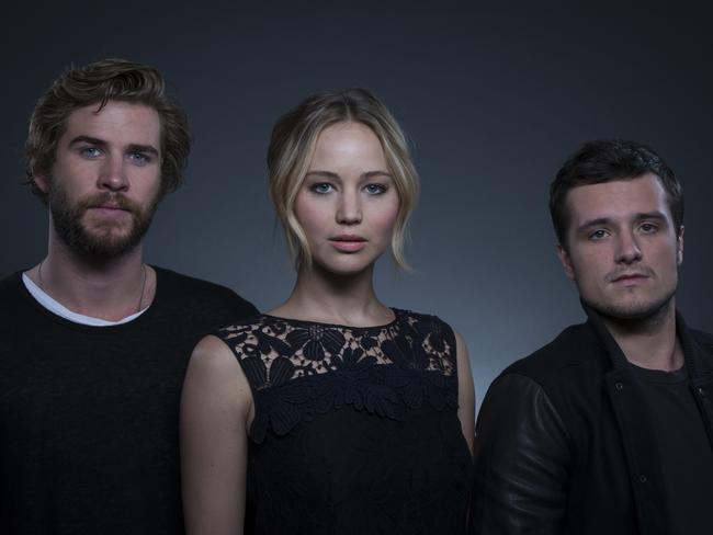 Jennifer Lawrence with her Mockingjay — Part 1 co-stars Liam Hemsworth (left) and Josh Hutcherson. Picture: Drew Gurian (Invision/AP)