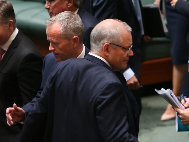 PM Scott Morrison and Opposition Leader Bill Shorten cross paths during a division in the House of Representatives Chamber at Parliament House in Canberra. Picture Kym Smith