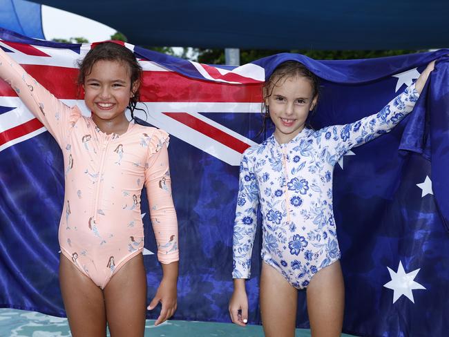 Best friends Lily Walia, 7, and Izzy Kinloch, 6, fly the Australian flag at Cairns Regional Council's Australia Day family fun day at the Woree Sports and Aquatic Centre. Picture: Brendan Radke