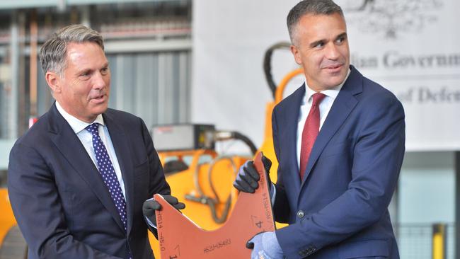 Deputy Prime Minister Richard Marles and Premier Peter Malinauskas at a ceremony in June, holding the first-cut piece of steel to be used on the first Hunter-class frigate to be constructed at the Osborne Naval Shipyard in Adelaide. Picture: NewsWire / Brenton Edwards