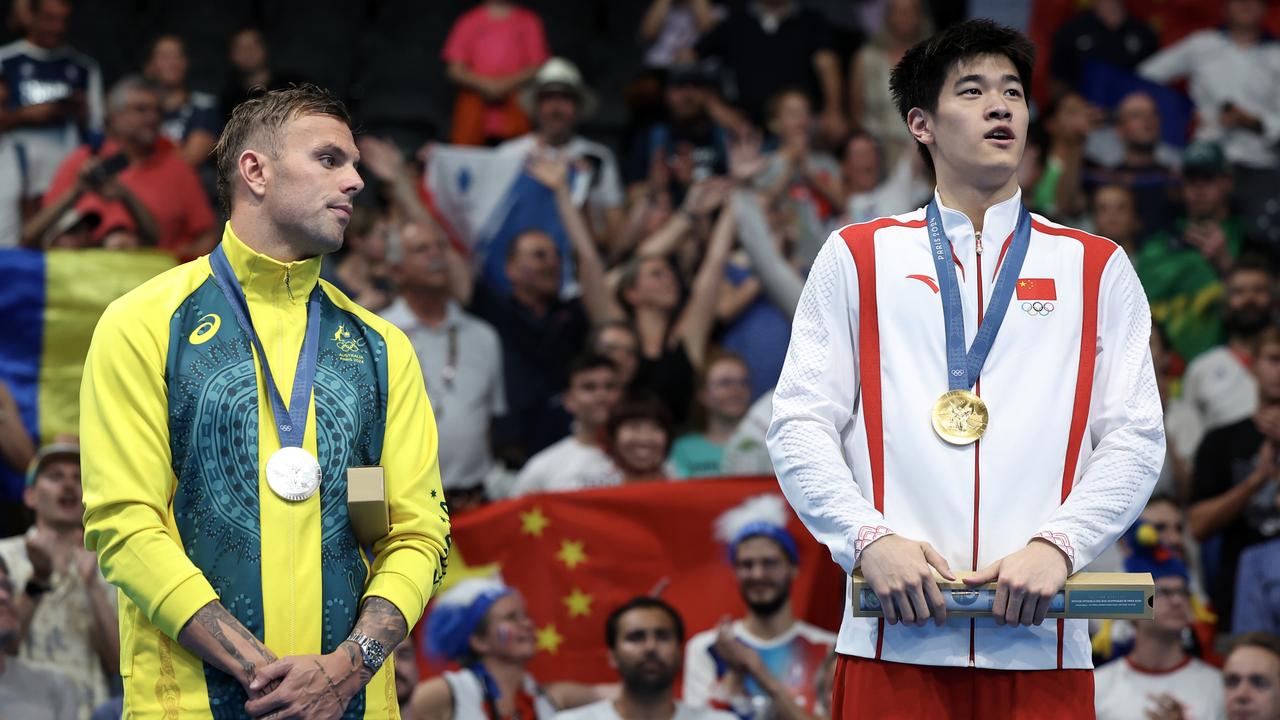 Kyle Chalmers and Zhanle Pan on the medal dais. (Photo by Quinn Rooney/Getty Images)