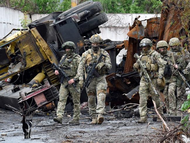 TOPSHOT - Russian servicemen patrol the destroyed part of the Ilyich Iron and Steel Works in Ukraine's port city of Mariupol on May 18, 2022, amid the ongoing Russian military action in Ukraine. (Photo by Olga MALTSEVA / AFP)