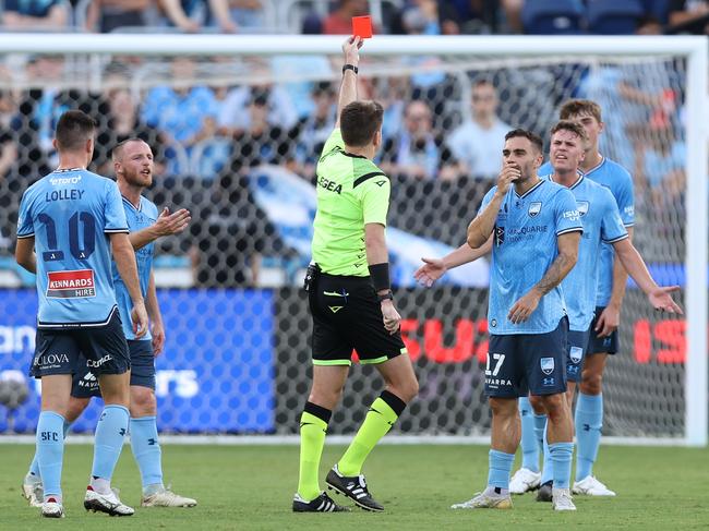 SYDNEY, AUSTRALIA - MARCH 10: Referee Adam Kersey issues a red card to Jake Girdwood-Reich of Sydney FC for his challenge on Nikola Mileusnic of the Roar during the A-League Men round 20 match between Sydney FC and Brisbane Roar at Allianz Stadium on March 10, 2024 in Sydney, Australia. (Photo by Jason McCawley/Getty Images)