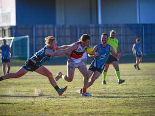 NOT GOING ANYWEHRE: Bay Power midfielder Marcus Dyson tries to tackle Bulldogs' fast-moving Joel Saunders. Picture: Brian Cassidy