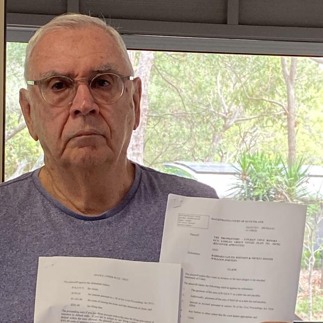 Couran Cove resident Ernie Johnson with the legal papers he received.