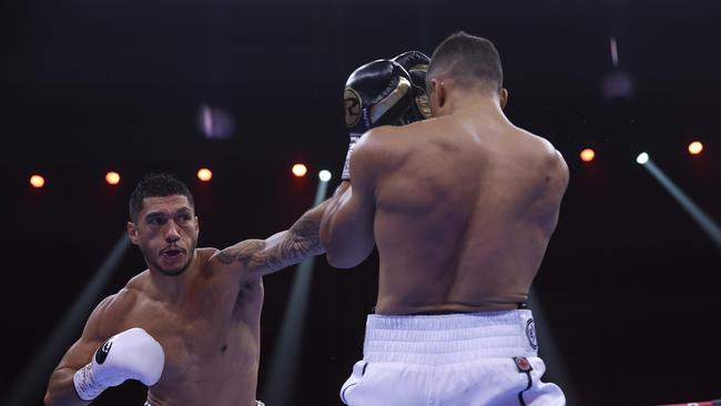 Australian heavyweight Jai Opetaia stands throws a combination at Englishman Ellis Zorro.