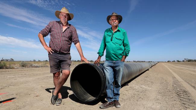 Darling River Farmer Rob McBride and Barkindji Elder Badger Bates pictured in 2018 showing construction of an unwanted pipeline meant to pump water from the Murray River at Wentworth to Broken Hill. Picture: David Geraghty