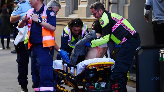 An injured woman is taken by ambulance from Hotel CBD at the corner of King and York Street in Sydney. PICTURE: AAP