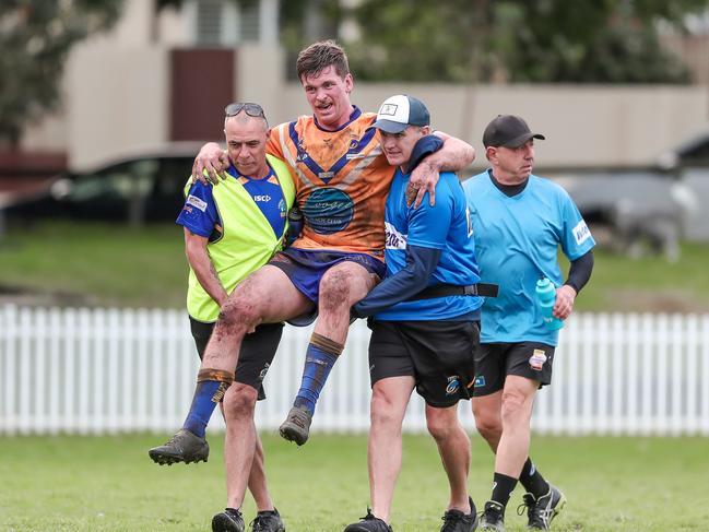 Cody Kelso carried from the field. Picture: Adam Wrightson Photography