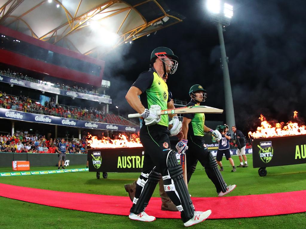 Australia's Chris Lynn and Aaron Finch walk out to bat during the T20 International match between Australia and South Africa, at Metricon Stadium, on the Gold Coast, Saturday, November 17, 2018.