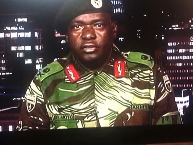 Zimbabwe Major General Sibusiso Moyo reads a statement at the ZBC broadcast studio where he denied staging a coup and used state television to vow to target “criminals: close to Mugabe. Picture: AFP