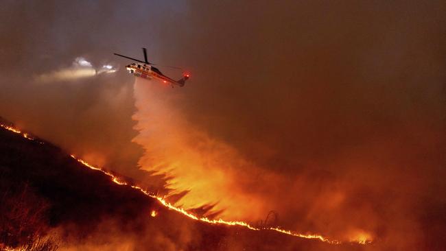 Water is dropped by helicopter on the Kenneth Fire in the West Hills section of Los Angeles. Picture: AP