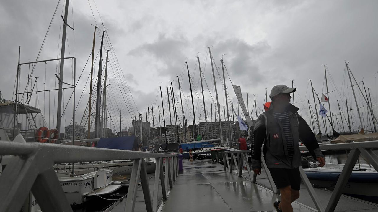 A man walks off a pontoon after the cancellation of the Sydney to Hobart yacht race due to an escalating coronavirus outbreak in 2020.