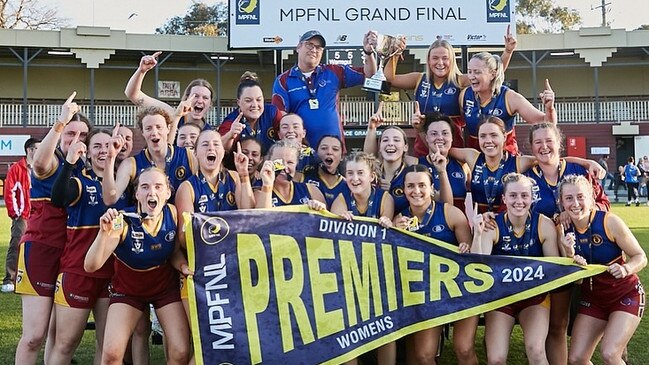 Warragul Industrials show off their 2024 premiership flag. Picture: Carly Ravenhall