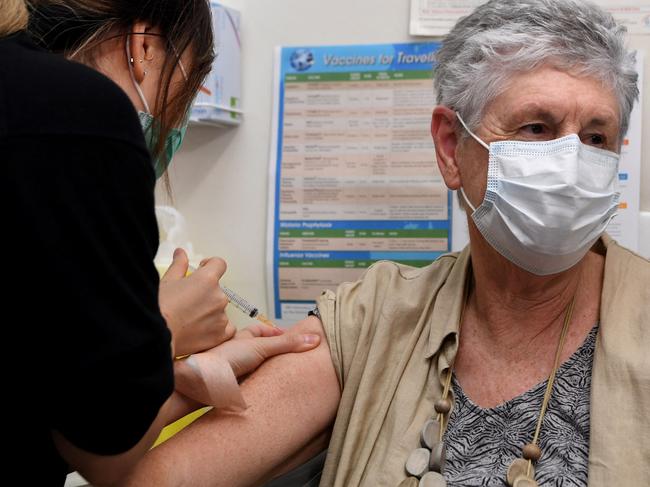 Anne Hyslop (R) receives an AstraZeneca vaccine from practice nurse Youri Park (L) in Melbourne on April, 7, 2021 as Australia's Prime Minister Scott Morrison blamed restricted vaccine supply from Europe for his country's halting coronavirus inoculation efforts, as he faced down growing public frustration over the sluggish rollout. (Photo by William WEST / AFP)