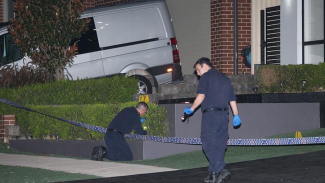 Police examine the scene of the shooting in Gregory Hills. Picture: Bill Hearne