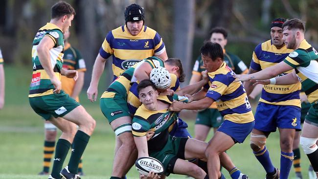 Surfers Paradise scrumhalf James Crisp offloads under pressure from Eagles player Shoma Okubo. Picture: Richard Gosling