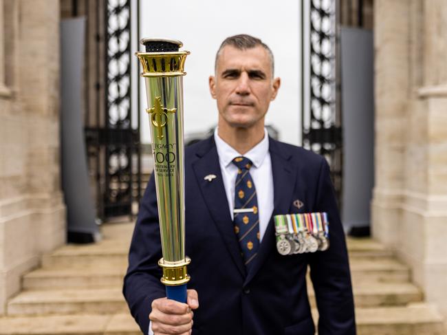 Legacy’s Ken Tsirigotis with the Legacy commemorative torch at Pozieres British Cemetery for the launch of the Legacy Centenary Torch Relay 2023, presented by Defence Health. Picture: Callum Smith