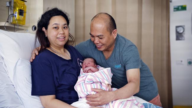 Siska Apriyanti Sim holds baby Shawn Cedric Biansi in her bed this morning with dad Budianto. Picture: Sam Ruttyn