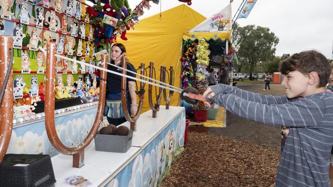 William Rowe 11yo tries his luck in sideshow alley on day 3 of the Toowoomba Royal Show. Sunday, March 27, 2022. Picture: Nev Madsen.