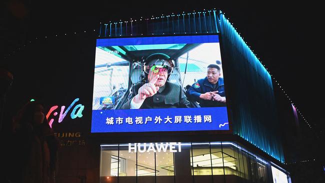 Chinese President Xi Jinping appears larger than life during a news program broadcast on a big screen in Beijing on Tuesday. Picture: AFP