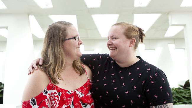 Louise Appleton and Amanda Gray pose for a photograph in South Brisbane. The two sisters have helped their brother and his partner have a child. (AAP/Sarah Marshall)