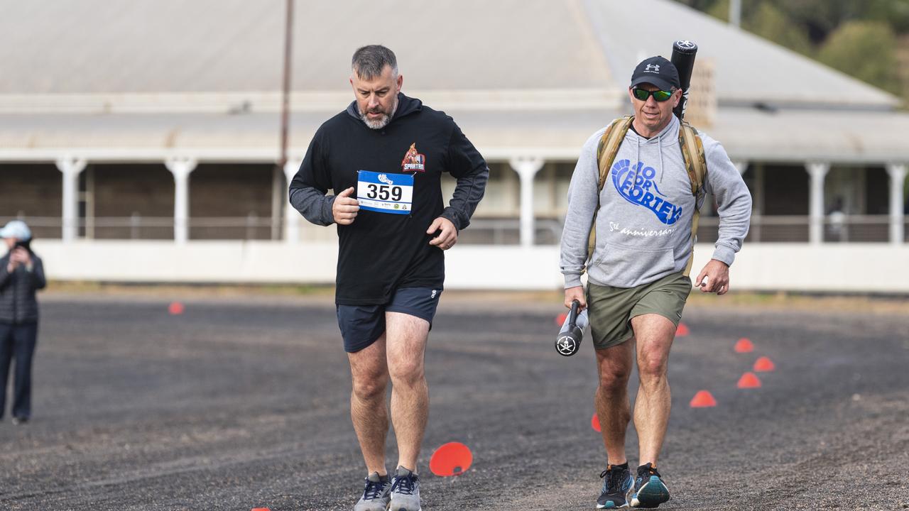 Spartans team members Des Brosnan (left) and Geordie Horn (carrying an extra 40kg) in 40 for Fortey at Toowoomba Showgrounds, Sunday, June 2, 2024. Picture: Kevin Farmer