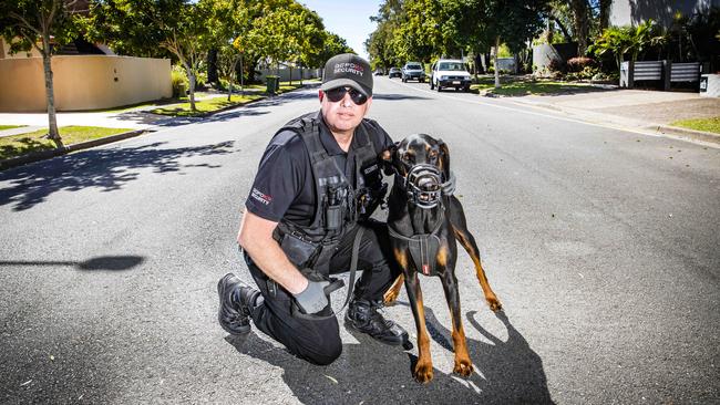 Security guard Wayne Heneker and his dog 'Boss', who has been hired by Gold Coast residents to patrol their suburbs. Picture: Nigel Hallett