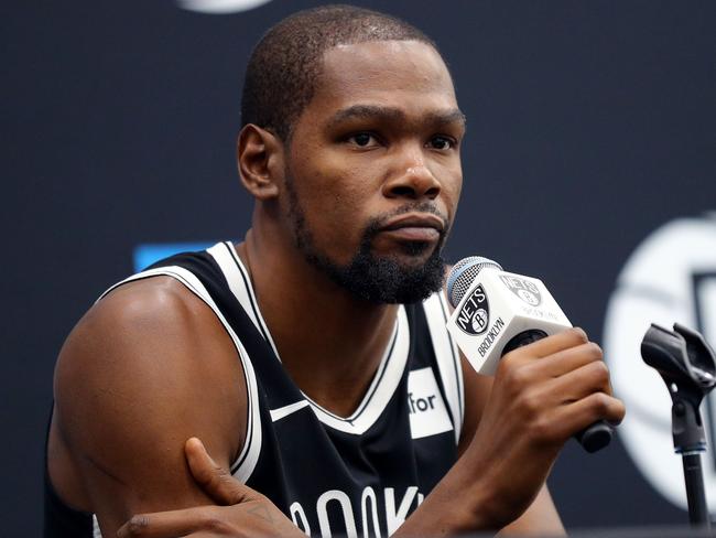 (FILES) In this file photo taken on September 26, 2019 Kevin Durant #7 of the Brooklyn Nets speaks to media during Brooklyn Nets Media Day at HSS Training Center on September 27, 2019 in the Brooklyn Borough of New York City. - Kevin Durant is among the four Brooklyn Nets players to test positive for the coronavirus, he told The Athletic on March 17, 2020. "Everyone be careful, take care of yourself and quarantine," Durant told The Athletic, adding that he is feeling fine and not showing any symptoms. "We're going to get through this." The Nets did not identify any players and said Tuesday that of the four players, only one is exhibiting symptoms. All four are isolated and are undergoing medical care from team physicians, the Nets said in a statement. (Photo by Mike LAWRIE / GETTY IMAGES NORTH AMERICA / AFP)