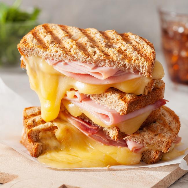 If you love a grilled ham and cheese sandwich, choose grated over block cheese to save money. Picture: iStock