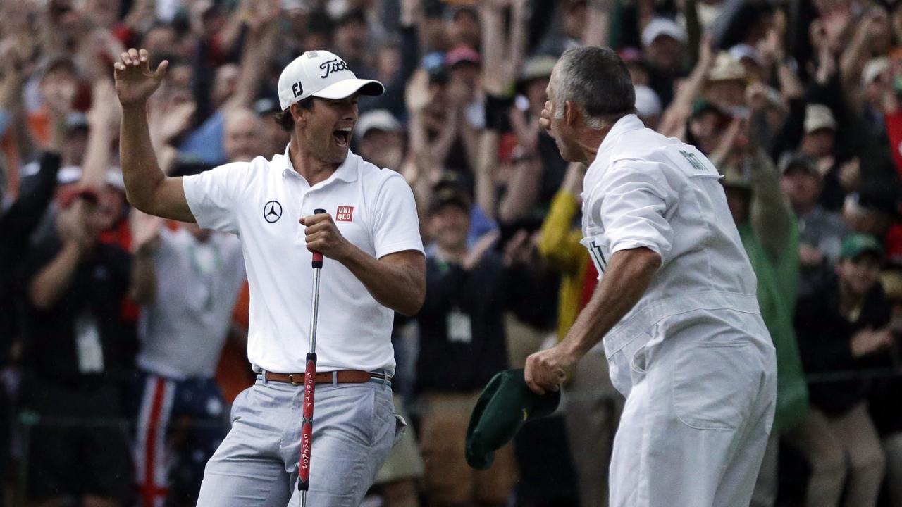 Adam Scott, of Australia, celebrates with caddie Steve Williams after making a birdie putt on the second playoff hole to win the Masters