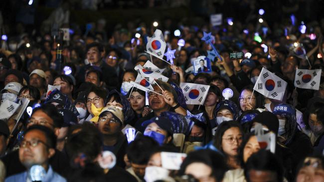 Supporters of Lee Jae-myung, the presidential candidate of the Democratic Party celebrate the news-update of the election result. Photo by Woohae Cho/Getty Images