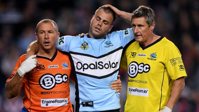 Wade Graham of the Sharks is assisted from the field by trainers after injuring his knee during the Qualifying Final between the Sydney Roosters and the Cronulla-Sutherland Sharks. Picture: AAP Image/Dan Himbrechts