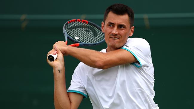 LONDON, ENGLAND — JULY 02: Bernard Tomic of Australia plays a backhand in his Men's Singles first round match against Jo-Wilfred Tsonga of France during Day two of The Championships — Wimbledon 2019 at All England Lawn Tennis and Croquet Club on July 02, 2019 in London, England. (Photo by Clive Brunskill/Getty Images)