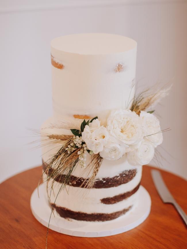 Two-tier partially naked cake in two flavours – chocolate brownie with salted caramel and white chocolate with lime curd  by Petal and Peach Bespoke Cakery, Wellington Point.