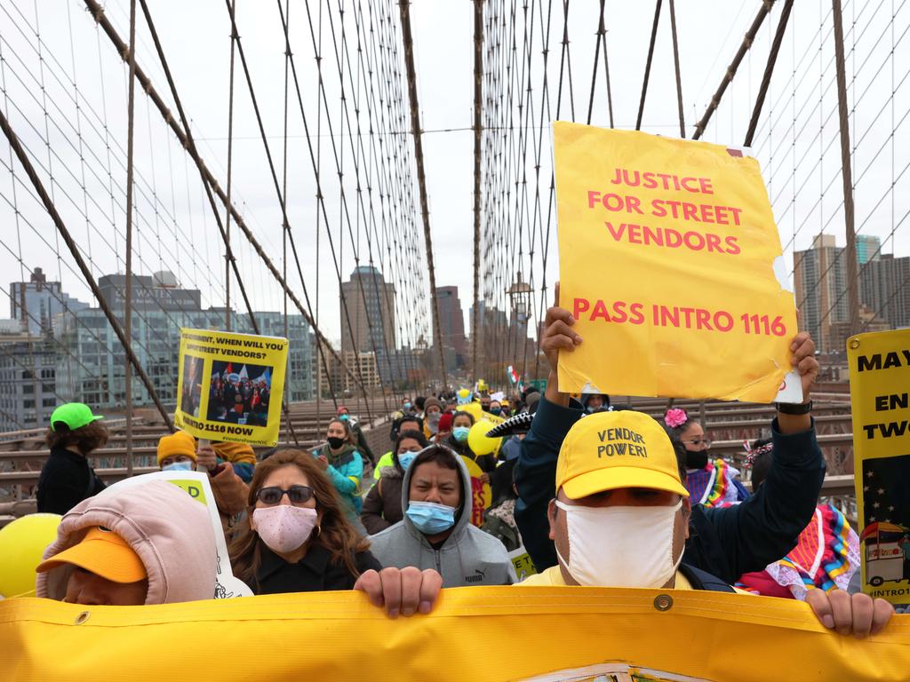 New York street vendors march across the Brooklyn Bridge to demand inclusion in coronavirus recovery efforts. Picture: Getty Images/AFP