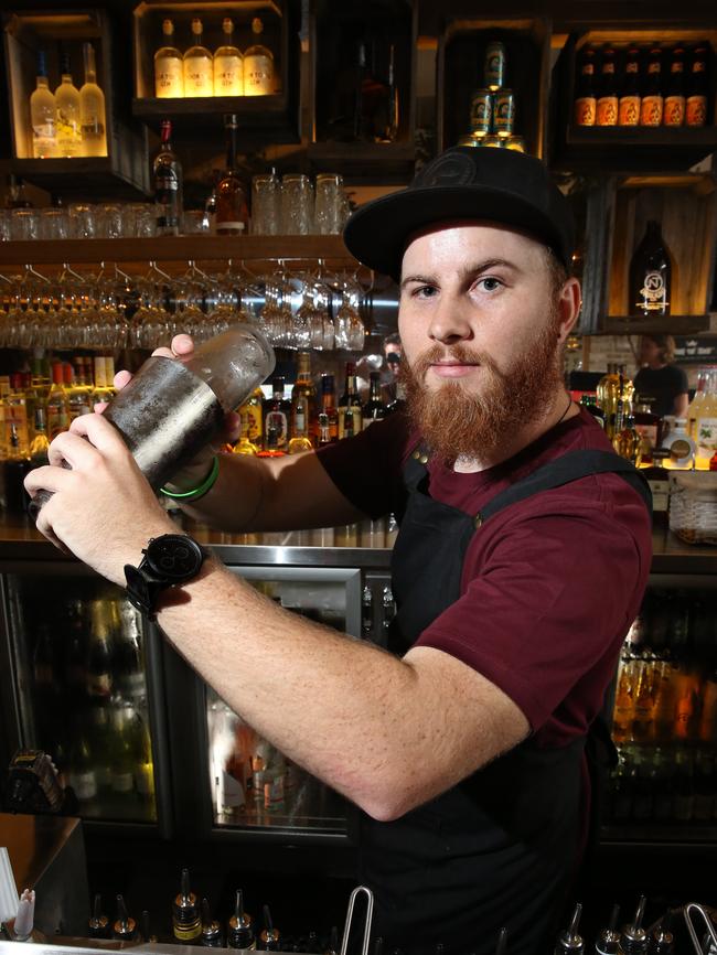 Luke Muller prepares a cocktail for customers.