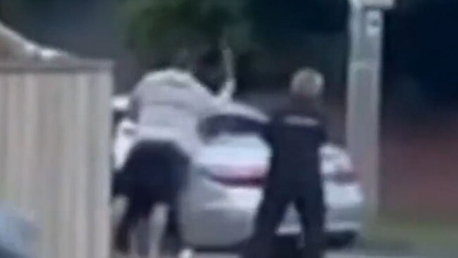 Video footage captures the passenger bashing the windows of the silver sedan with a hammer.