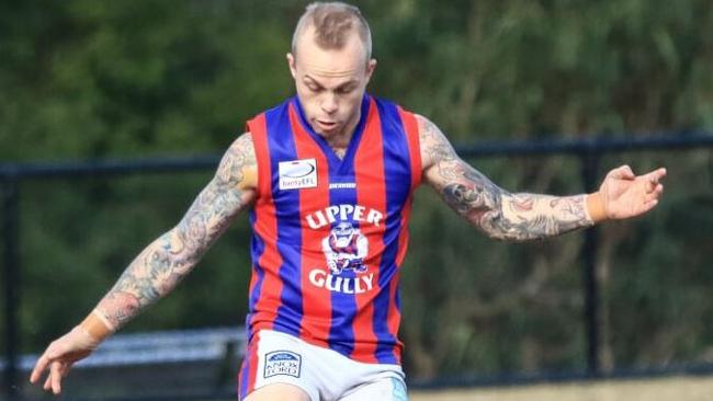 Upper Ferntree Gully’s Jordan Whiteman gets boot to ball. Picture: Davis Harrigan