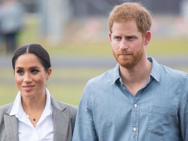 DUBBO, AUSTRALIA - OCTOBER 17:  Meghan, Duchess of Sussex and Prince Harry, Duke of Sussex attend a naming and unveiling ceremony for the new Royal Flying Doctor Service aircraft at Dubbo Airport on October 17, 2018 in Dubbo, Australia. The Duke and Duchess of Sussex are on their official 16-day Autumn tour visiting cities in Australia, Fiji, Tonga and New Zealand.  (Photo by Dominic Lipinski - Pool/Getty Images)