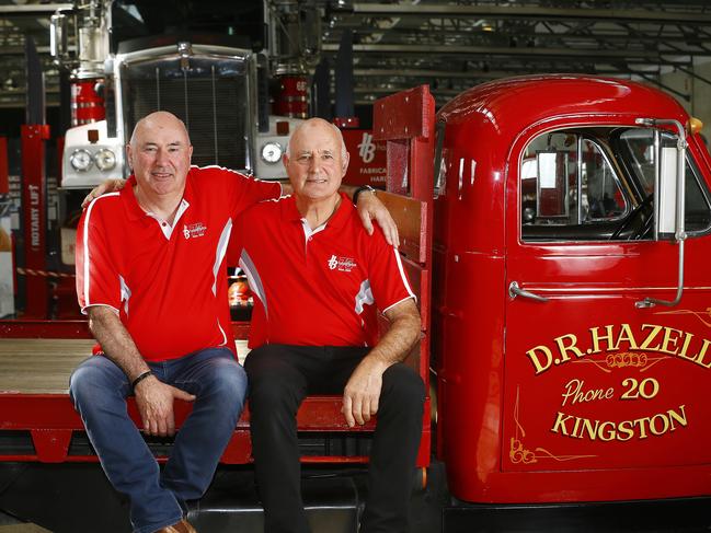 Brothers Geoffrey, left, and Robert Hazell on the back of one of the company’s first trucks as the company celebrates its 75th anniversary. Picture: MATT THOMPSON