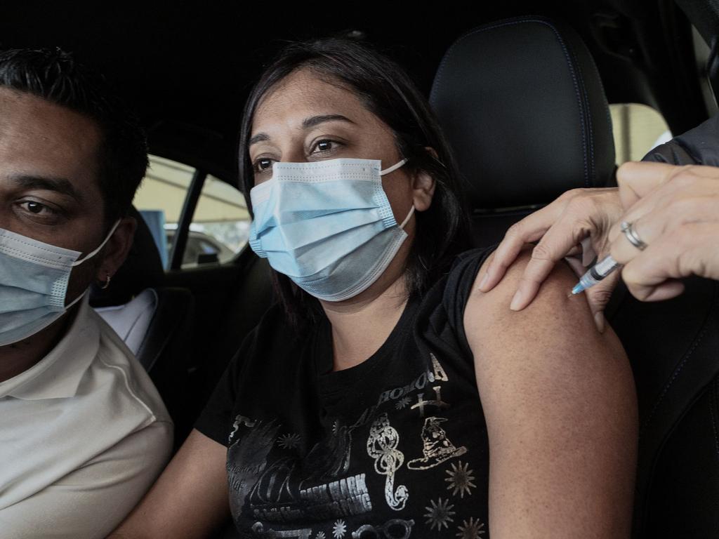 A South African woman receives her first dose of Pfizer at a drive-through vaccination site. Picture: Luca Sola/AFP