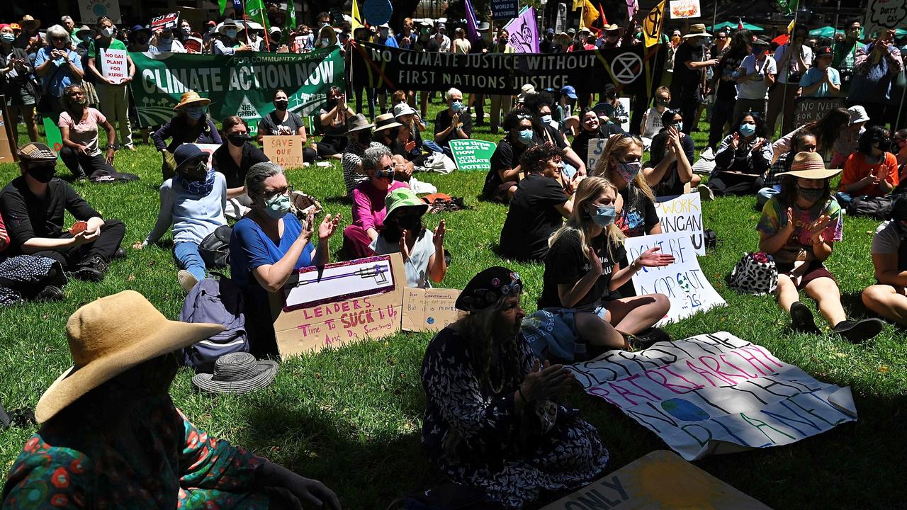 People participate in a rally during a global day of action on climate change in Sydney on November 6, 2021, as world leaders attend the COP26 UN Climate Change Conference in Glasgow. (Photo by Steven Saphore / AFP)