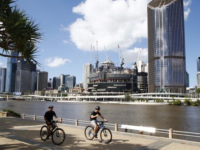 BRISBANE, AUSTRALIA - NewsWire Photos JANUARY 10, 2022: Queenslanders braced for more wild weather as Tropical Cyclone Tiffany made landfall on the east coast. Brisbane residents struggled through extremely hot weather, with many cooling off at the South Bank beach and walking and cycling next to the Brisbane river. Picture: NCA NewsWire/Tertius Pickard