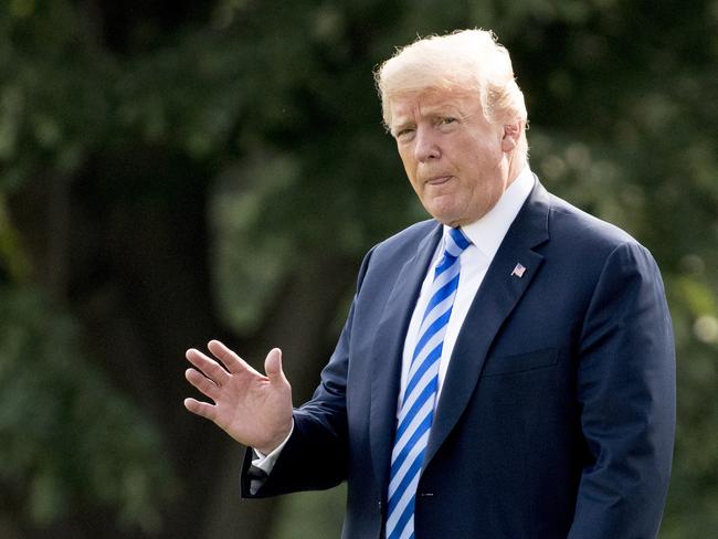 President Donald Trump waves to members of the media as he boarded Marine for a short trip to visit his wife. Picture: AP