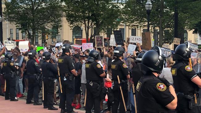 Kenosha County Sheriff’s officers stand in front of protesters at the county court house. Picture: AFP