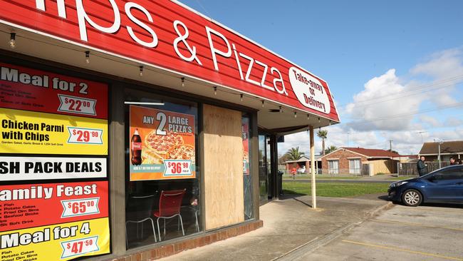 The Corio fish and chip shop was back open and serving customers on Tuesday. Only one boarded up window was a clue to the events. Picture: Alan Barber