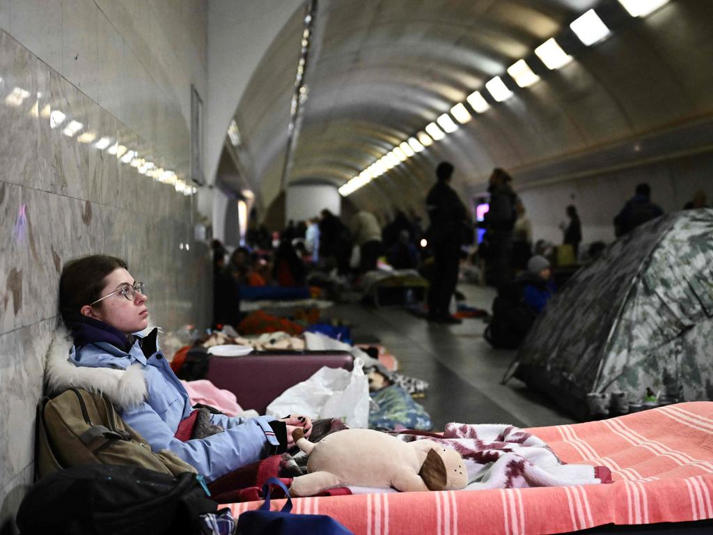 A young woman sits in an underground metro station used as bomb shelter in Kyiv. Picture: STF/AFP