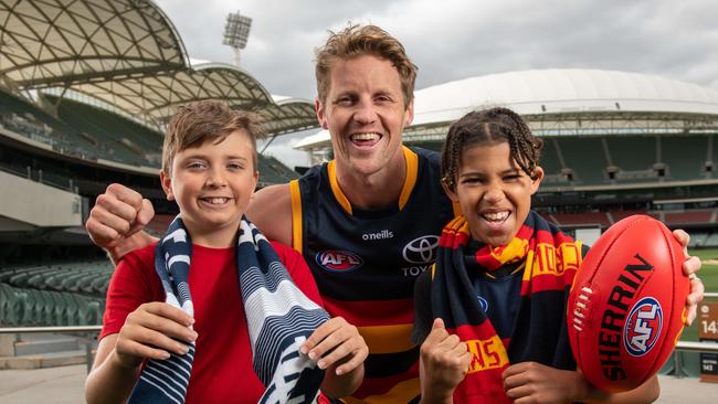 Crows captain Rory Sloane with football fans Jake O’Neill and Thomas Mack at Adelaide Oval. Picture: NCA NewsWire/Naomi Jellicoe